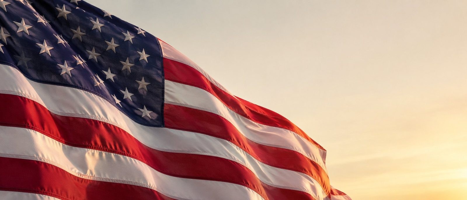 An American flag flying in golden sunlight